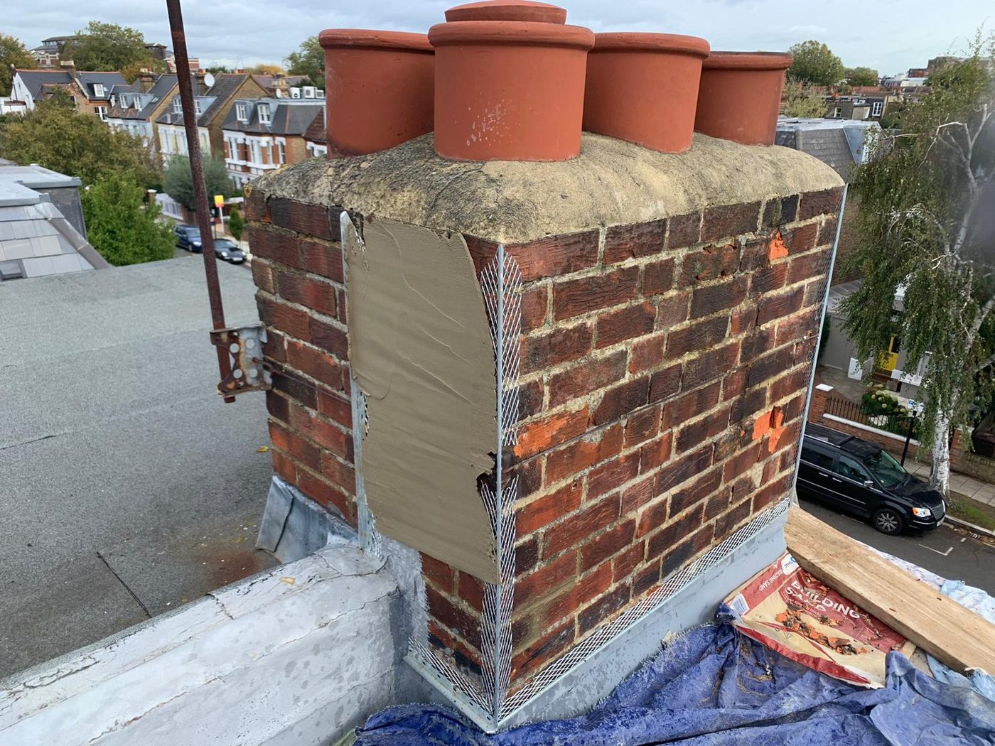 Chimney repointing and repair in progress by Redline Roofing